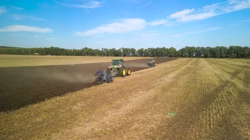 Tractors plowing the field in Ukraine