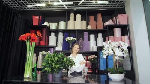 Smiling Woman Behind Flower Shop Counter