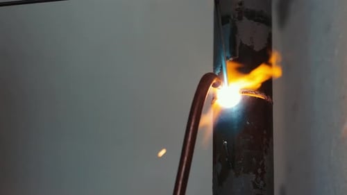Welding a Metal Pipe Closeup of a Welder Working on a Metal Pipe