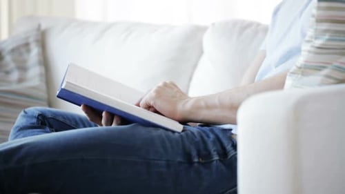 Leisure, Education, Literature and People Concept - Close Up of Man Sitting