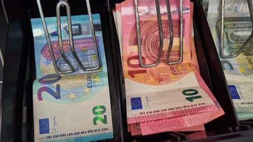 Showing some euro currency banknotes on panning movement in a cash register, France.