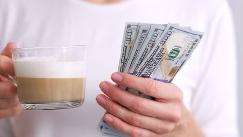 Woman with Coffee and Cash Money American Dollars Banknotes Hands with Money Close Up Income Winner