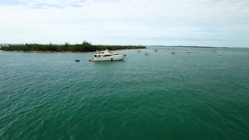 Luxury yacht anchored in a blue tropical paradise next to sailboats in Florida