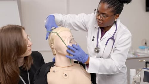 Medical Students Practice Oxygen Mask Procedure on Mannequin