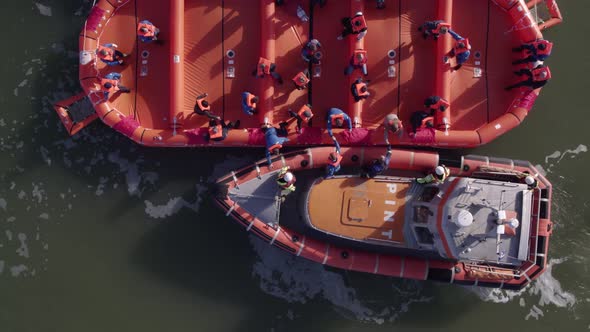 Aerial view of launching of a life raft in calm water, Harlingen ...
