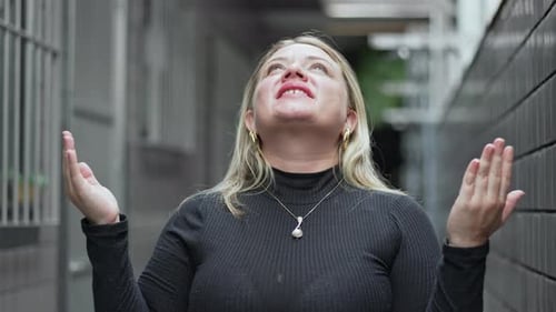 Woman Looks to the Sky, Hands Together Praying