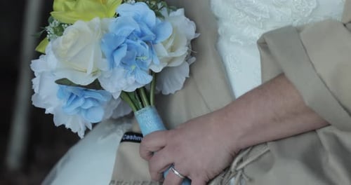 Elegant Bride Holding White and Blue Bouquet