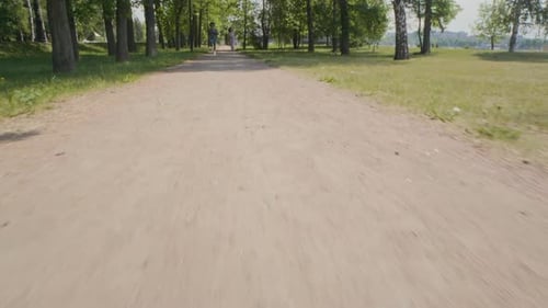 Young Couple Running Together in Park