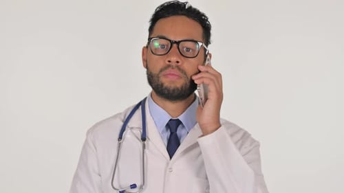 Male Doctor Talking on Phone in Lab Coat