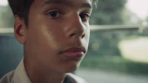 Portrait of Sad Indian School Boy Looking Camera in Students Vehicle. Thoughtful