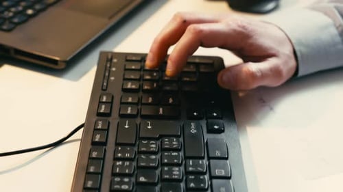 The detective's hands move swiftly as they enter data on a keyboard, followed by a close examination