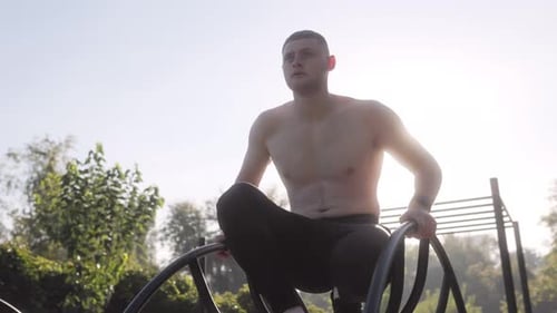 Fit Young Athlete with Naked Torso Resting After Outdoor Training