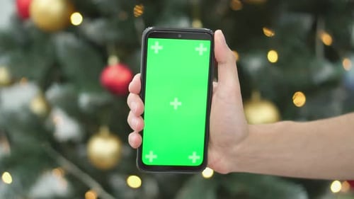 Hand Holding Smartphone with Green Screen on Chroma Key