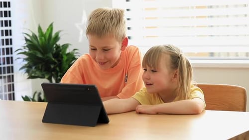 Cute Brother and Sister Joyfully Use the Tablet Together Digital Technologies