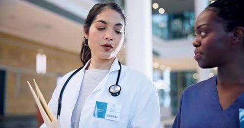 Walking, team and women talking, doctors and consulting in a hospital, intern with questions