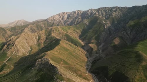 La hora dorada a través de las crestas cubiertas de hierba de la cordillera de Baysuntau, Boysun, Uzbekistán