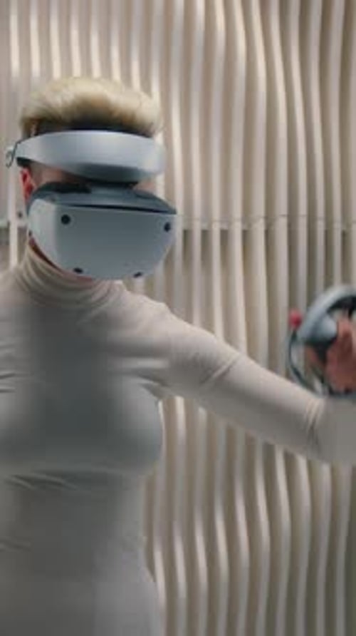 Woman in VR Headset Uses Controllers in Studio