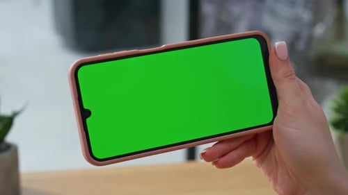Woman Holding Phone with Green Screen Tapping