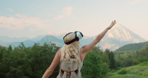 Woman Wearing VR Headset in Mountain Landscape
