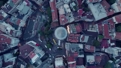 Birdseye drone flight spinning over the Galata tower and the city around of Istanbul on a grey day