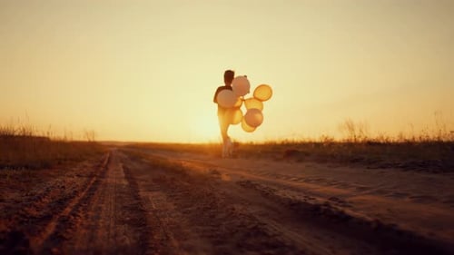 Be Happy and Carefree Little Boy with Balloons in Hand Running on Field Beautiful Scenery in Rural