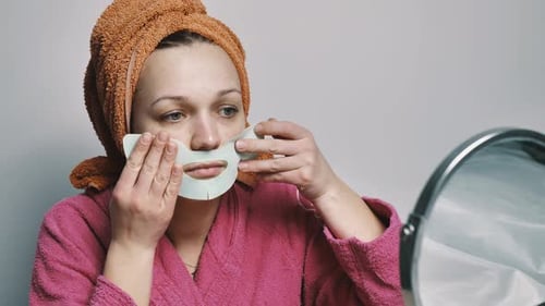 Woman Applies a Mask on Her Face
