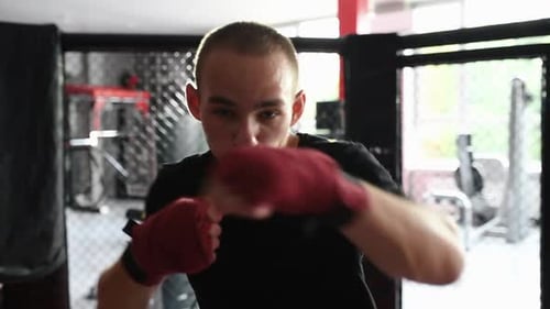 Close view of boxer practicing indoors at gym at daytime