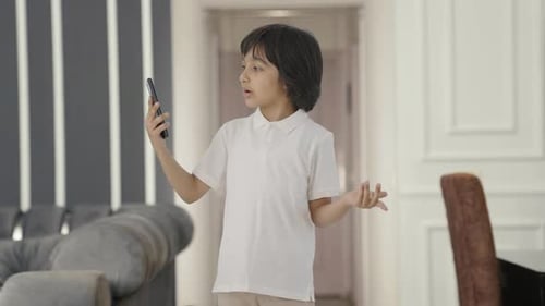 Boy Having Video Call on Smartphone Indoors
