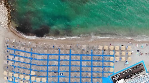 Aerial View of Beach Umbrellas and Turquoise Ocean
