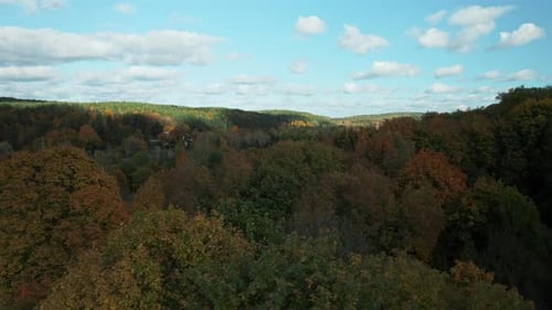 AERIAL: stunning fall colours in the mountain countryside scenery