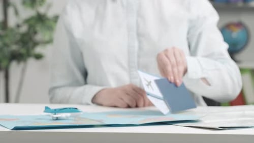 Woman Prepares Passport and Tickets for Travel