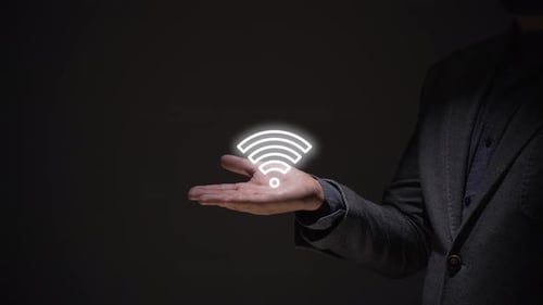 concept of wifi networks. business person teaches wifi network hologram