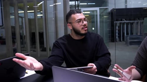 Man Gesturing During Productive Meeting in Modern Office