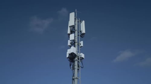 A Mobile Communication Tower Stands Tall Against the Clear Beautiful Blue Sky Above Head