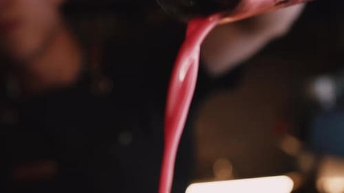 Bartender Pouring Cocktail Into Glass