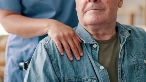 Caregiver Supports Senior Man in Wheelchair