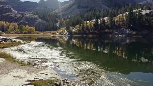 Aerial drone shot of Lake Blanche in Utah’s Big Cottonwood Canyon. The camera dollys in and tilts up