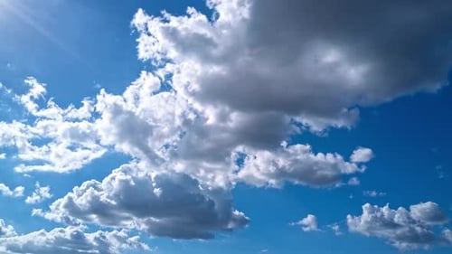 White Clouds Drifting Across Vivid Blue Sky