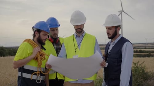 Engineers Reviewing Plans at Wind Turbine Site