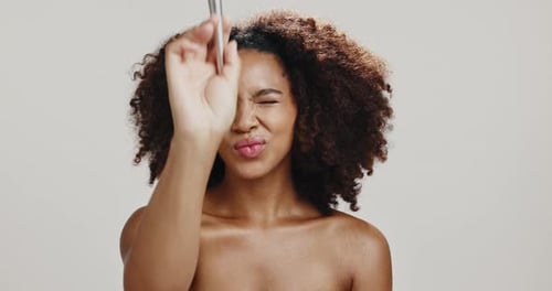 Face, woman and brush for makeup, shine or foundation for skin with cosmetics, studio or pout