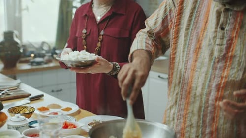 Man and Woman Cooking Together in Kitchen