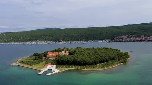 Small Island surrounded by turquoise waters - Cinematic Aerial view