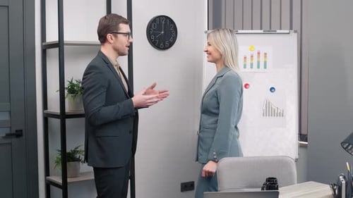 Two happy professional business partners executive leaders shaking hands at office meeting. Smiling