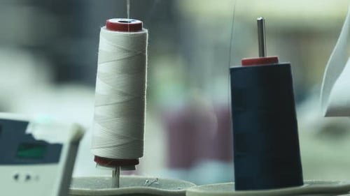Close-up shot of cotton threads for sewing machine in action.