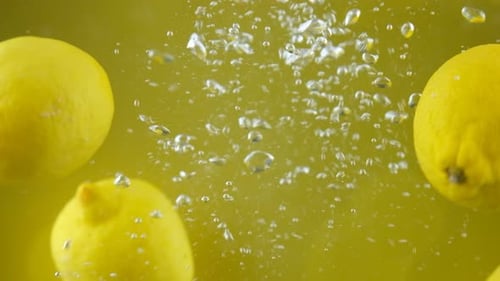 Lemons Splashing into Clear Water, Close Up