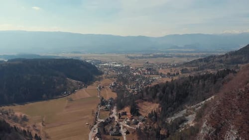 Drone shot of a beautiful village, small city, town surrounded with mountains