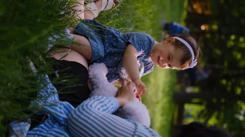 Mother and child together in the park outdoors, lying in the grass. Motherhood happiness concept. Da