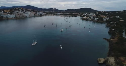 Drone Shot flying over the Sea with a lot of Boats near the coast, 4k UHD