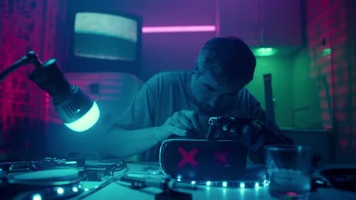 Man Assembling Futuristic Goggles in Cyberpunk Room