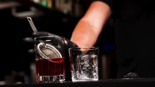 the bartender prepares a cocktail at the bar